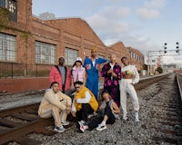 a group of people posing on a train track